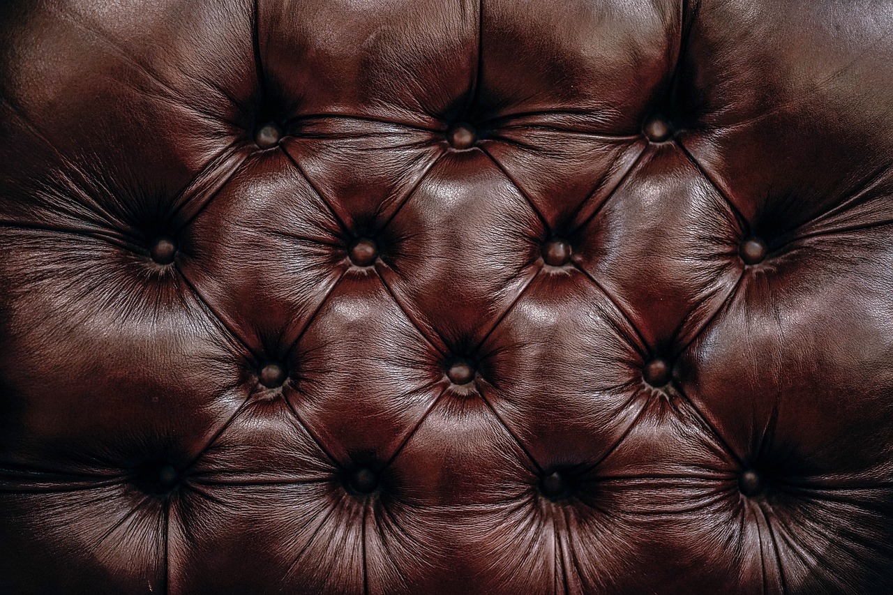 A close-up of luxurious leather upholstery, showcasing rich textures and stitching details.